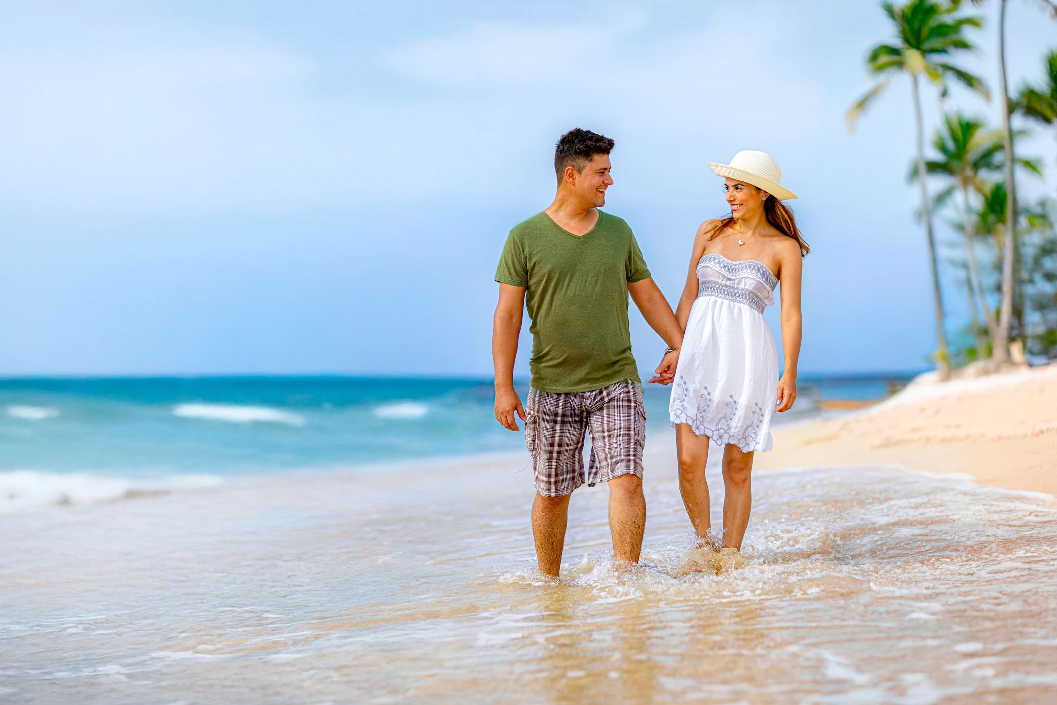 Couple walking along a tropical island beach