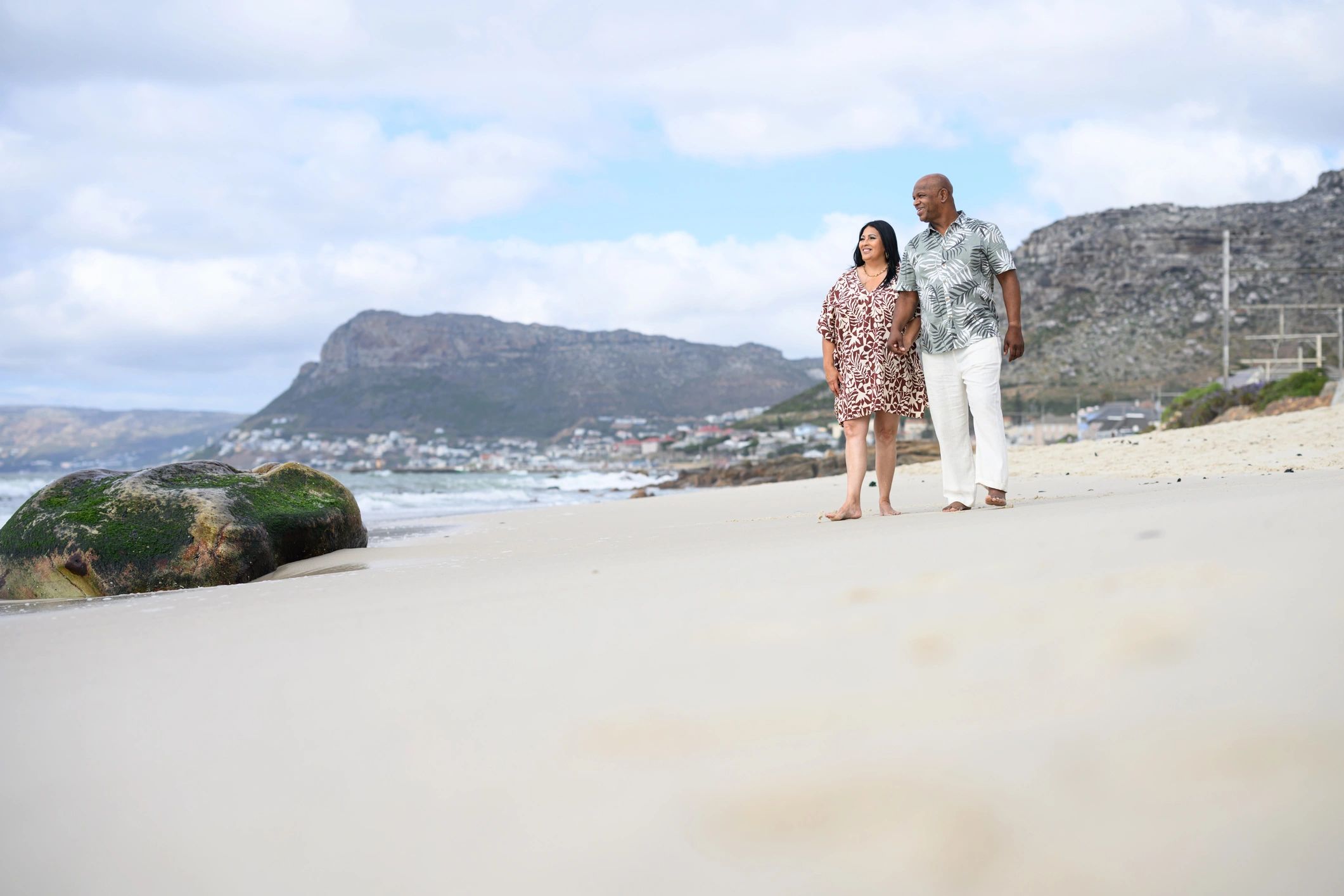 Couple walking hand in hand on a beach